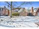 Brick home with snow-covered lawn, mature tree, and walkway at 5710 N Delaware St, Indianapolis, IN 46220