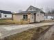 Tan house with a wooden deck and gravel driveway at 633 S 17Th St, Elwood, IN 46036