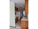 Kitchen with wood cabinets, white appliances and yellow oven at 6628 E Michigan St, Indianapolis, IN 46219