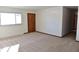 Bright living room with hardwood floors and large window at 6628 E Michigan St, Indianapolis, IN 46219