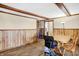 Bright dining room with wood flooring and wood-paneled walls at 6951 E Michigan Rd, Waldron, IN 46182