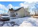 Gray siding house with snowy yard and a white car at 6951 E Michigan Rd, Waldron, IN 46182