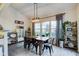 Bright dining room with farmhouse table and large windows at 714 Keepsake Run, Greenwood, IN 46143