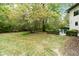 Landscaped backyard with mature trees and patio at 7812 Preservation Dr, Indianapolis, IN 46278