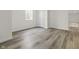 Spacious basement room with light wood flooring and a window at 7812 Preservation Dr, Indianapolis, IN 46278