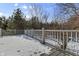 Snow-covered deck with gray railings overlooking a wooded area at 7812 Preservation Dr, Indianapolis, IN 46278