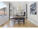 Modern dining room with hardwood floors and large windows offering natural light at 7812 Preservation Dr, Indianapolis, IN 46278
