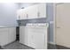 Laundry room with washer, dryer, and ample cabinet space at 7812 Preservation Dr, Indianapolis, IN 46278