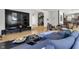 Open living space with hardwood floors, large TV, and comfortable seating at 7812 Preservation Dr, Indianapolis, IN 46278