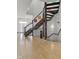 Modern, winding staircase with dark wood and metal accents at 7812 Preservation Dr, Indianapolis, IN 46278