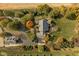 Overhead aerial view of a home with a well manicured lawn, mature trees, and patio outdoor seating at 8552 E 550 S, Zionsville, IN 46077