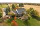 Aerial view of a brick home on a large lot with mature trees and a patio area with outdoor seating at 8552 E 550 S, Zionsville, IN 46077