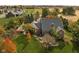 Aerial view of a beautiful brick home with lush greenery and mature trees in a serene neighborhood at 8552 E 550 S, Zionsville, IN 46077