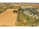 Aerial view of property bordering farmland and neighborhood, showcasing the home's location and surrounding landscape at 8552 E 550 S, Zionsville, IN 46077