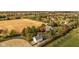 Aerial view of estate showing home, barn, horse area, outbuildings and neighboring community at 8552 E 550 S, Zionsville, IN 46077