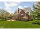 Expansive backyard featuring a brick house, lush lawn, patio, and outdoor fire pit at 8552 E 550 S, Zionsville, IN 46077