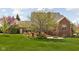 This backyard features a brick patio, a firepit, and a spacious lawn at 8552 E 550 S, Zionsville, IN 46077