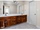 Bathroom with double sinks, wooden cabinets, and tiled flooring at 8552 E 550 S, Zionsville, IN 46077