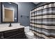Cozy bathroom with a dark vanity, mirror and a shower with neutral tones at 8552 E 550 S, Zionsville, IN 46077