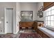 Inviting bathroom features custom cabinets, a large mirror, decorative lighting, and a cozy window seat at 8552 E 550 S, Zionsville, IN 46077