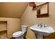 Bathroom featuring a pedestal sink, toilet, mirror and built in storage at 8552 E 550 S, Zionsville, IN 46077