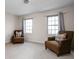 Cozy bedroom with two armchairs, natural light, and neutral carpet at 8552 E 550 S, Zionsville, IN 46077