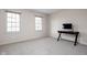 Simple bedroom with two windows, a desk, and neutral carpet at 8552 E 550 S, Zionsville, IN 46077