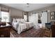 Spacious bedroom with a large bed, area rug, and a sliding barn door leading to the bathroom at 8552 E 550 S, Zionsville, IN 46077