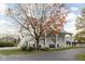 Charming exterior view of the barn with a staircase, porch, and a lush front yard tree with orange leaves at 8552 E 550 S, Zionsville, IN 46077