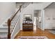 Inviting foyer featuring a staircase, hardwood floors, and a stylish console table with decor at 8552 E 550 S, Zionsville, IN 46077