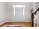 Bright foyer featuring hardwood floors, white door with sidelights and transom window, and access to the upper level at 8552 E 550 S, Zionsville, IN 46077