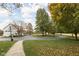 Scenic view of the expansive front yard with a circular driveway leading to the barn, and fall foliage at 8552 E 550 S, Zionsville, IN 46077
