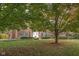 Charming two-story brick home with a lush front yard featuring mature trees, landscaping, and a welcoming entrance at 8552 E 550 S, Zionsville, IN 46077