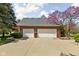 Brick two car garage with white doors and mature trees with landscaping at 8552 E 550 S, Zionsville, IN 46077