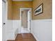 Hallway with wood floors, paneled walls, wallpaper, built-in bench, and access to other rooms at 8552 E 550 S, Zionsville, IN 46077