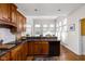 Well-equipped kitchen with granite countertops, wooden cabinets, and an adjacent breakfast nook at 8552 E 550 S, Zionsville, IN 46077