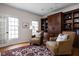 Inviting living room featuring built-in bookcase, large windows, hardwood flooring, and comfortable seating at 8552 E 550 S, Zionsville, IN 46077