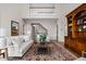 Spacious living room with hardwood floors, featuring a large sofa and a decorative wooden cabinet at 8552 E 550 S, Zionsville, IN 46077