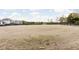 Expansive dirt paddock, ideal for equestrian activities, surrounded by a black wooden fence for security at 8552 E 550 S, Zionsville, IN 46077