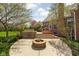 Inviting patio area with a stone fireplace, grill, and a raised deck with stairs at 8552 E 550 S, Zionsville, IN 46077