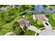 Aerial view of a home with a well manicured lawn and a pond with lush trees in the background at 861 Stardust Ct, Franklin, IN 46131