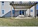 Outdoor patio features a pergola, seating, and sliding glass doors, providing an inviting outdoor space at 861 Stardust Ct, Franklin, IN 46131