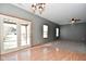 Gathering room with hardwood floors, carpet, and access to patio at 861 Stardust Ct, Franklin, IN 46131