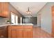 Kitchen boasts oak cabinets, granite counters, and views to Gathering room at 861 Stardust Ct, Franklin, IN 46131