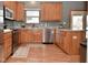 Modern kitchen with oak cabinets, granite countertops, and stainless steel appliances at 861 Stardust Ct, Franklin, IN 46131