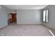 Grey living room with carpet and two windows at 861 Stardust Ct, Franklin, IN 46131