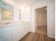 Bright bathroom features double vanity, quartz countertops, and wood look flooring; a closet is visible at 8703 Duncan St, Fortville, IN 46040