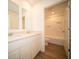Bright bathroom features double vanity, quartz countertops, and wood look flooring; a bathtub is visible at 8703 Duncan St, Fortville, IN 46040
