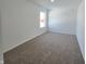 Spacious bedroom with neutral carpeting and window at 8703 Duncan St, Fortville, IN 46040