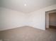 A bright bedroom featuring carpet, a window, and a door frame at 8703 Duncan St, Fortville, IN 46040